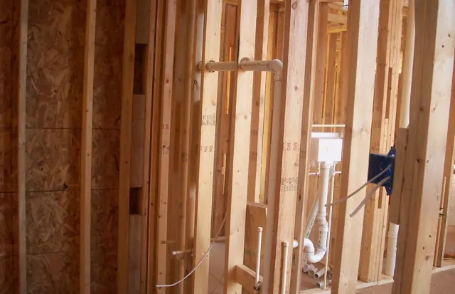 Plumbing roughed in inside framed bathroom walls