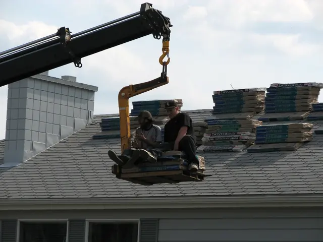 Crew installing shingles on a roof